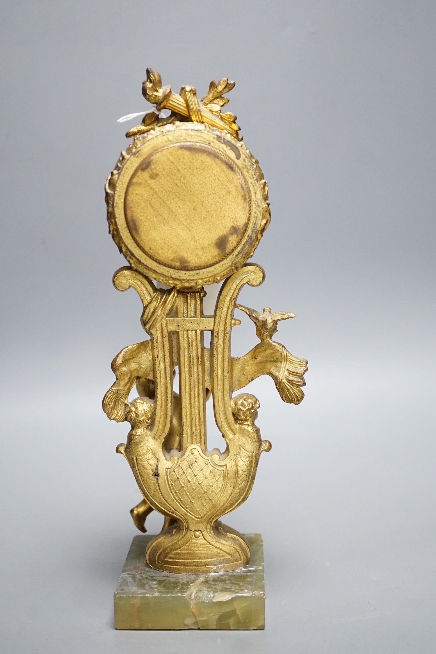 An early 20th century gilt metal cherubic mantel timepiece on onyx base, 29cm